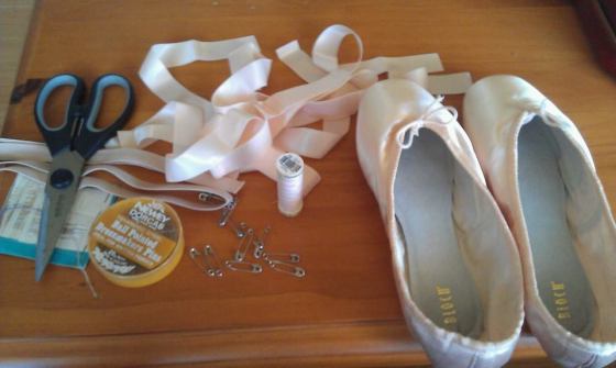 Shoes, elastics, ribbons, needle, thread and scissors. 